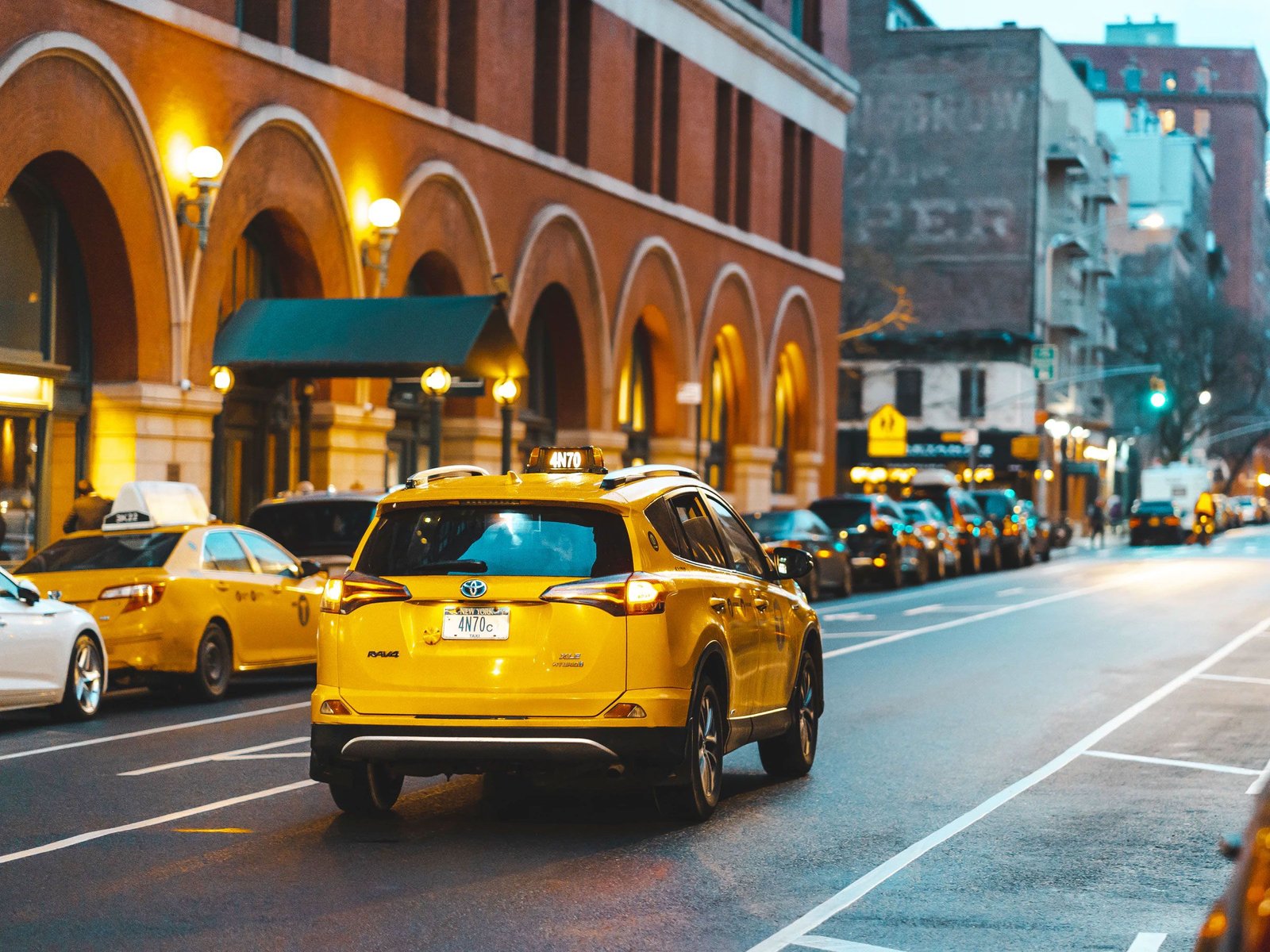Taxi Driving Down the Street